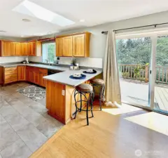 The open floor plan is light and airy with lots of windows, slider and skylight.