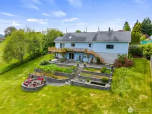 Terraced backyard with perennial gardens, water feature and fire-pit just add to the outdoor enjoyment.