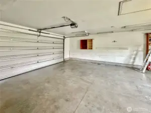 Oversize, attached 2 car garage with electric door opener, heater and side door granting access to the rear deck and grounds.
