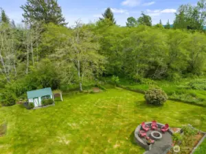 Beautiful grounds with garden space, fireplace pit, water feature, terraced beds and perennials everywhere.