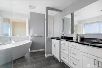 Primary Bath is adjacent to the Primary bedroom with dual sink vanity & Quartz countertops, vinyl plank flooring, and a Toto bidet toilet.