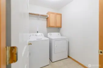Main floor utility room with storage space.  Washer and dryer included with the sale.