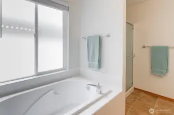 Primary bath offers a deep soaking tub and separate shower.