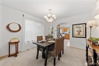 Located between the kitchen and formal living room, this area will comfortably fit several guests around the table.