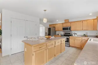 The pantry is behind the double doors and is spacious! Built in shelving on the right side and the left is open and perfect for all your Costco trips.