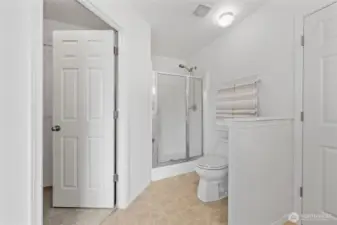 View of the walk-in closet and stand-alone shower.  Pony wall provides additional privacy.