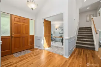 Here's a peek into the office with 6 panel wood double-door entry. Stairs to the right here take you upstairs to the bedrooms.