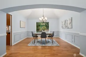 Another gorgeous room with hardwoods, newer light fixture, large window looking out at the backyard. Lots of room here to add additional furniture pieces.