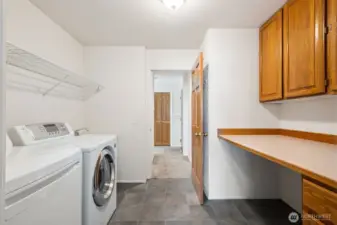 Here's the laundry room with built-in storage, flooring is ceramic tile here.