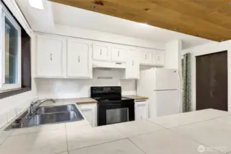 Wood cabinets.  Tile counter tops.  Wood trim.  All appliances / fixtures work!