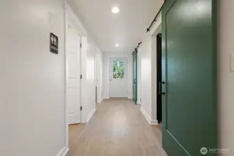 Salon back hallway with / bath, kitchen area and 2 massage rooms