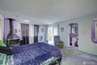 Primary bedroom leading to own deck via French doors