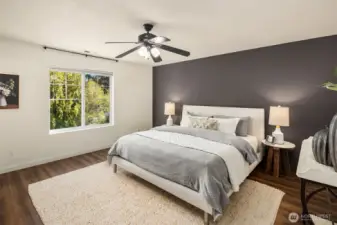 Relaxing primary suite with modern palette, walk-in closet, and ensuite bath.