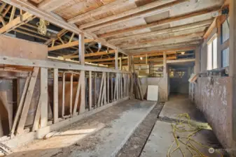 Barn interior with livestock area and head gates.