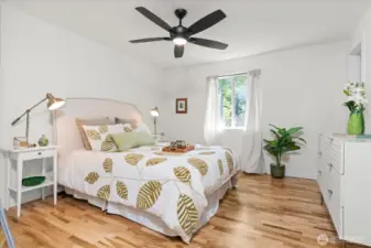 Sizable primary suite with new ceiling fan and rich hardwood flooring