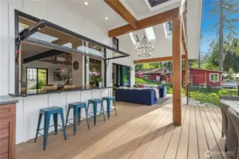 The pivot window opens to create a pass through for effortless outdoor dining.