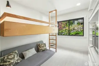 Second additional main floor bedroom with built-in loft bed.