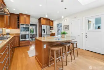The kitchen was updated with wood cabinets running up to the ceiling, breakfast island and dining area.