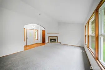 Living room with natural light and gas fireplace.