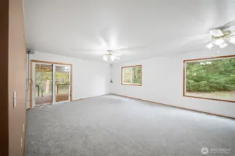 Down the hall you enter the family room with access to the covered deck. Surrounded with beautiful greenery out every windwo.