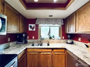 Kitchen with stainless steel appliances, amply cupboards and granite countertops, LVP flooring, with updated lighting