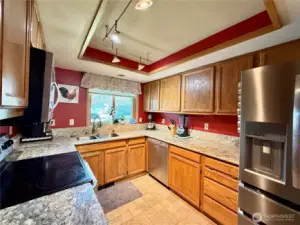 Kitchen with stainless steel appliances, amply cupboards and granite countertops, LVP flooring, with updated lighting