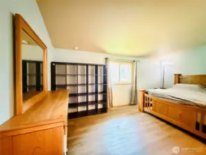 Primary suite view from the entryway, vaulted ceiling, LVP, spacious layout