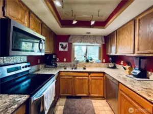 Kitchen with stainless steel appliances, amply cupboards and granite countertops, LVP flooring, with updated lighting