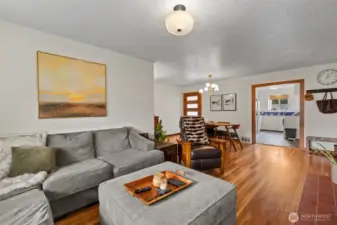 Living room gives ample natural light with the beautiful hardwood floors with a through feeling into the kitchen and dining area.