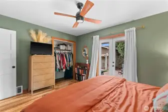 The primary with french doors opening out to the patio.