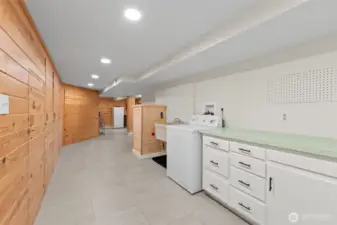 The laundry has so much storage, a huge wash basin and incredible wall storage behind the beautiful pine tongue and grove wall