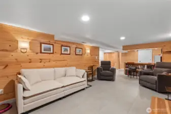 The downstairs living space gives a feel like no other. The modern look and feel of the new LVP floor is kept warm and cozy wit the pine tongue and groove walls paired with wall sconces that give the perfect subtle light for those cozy movie nights.