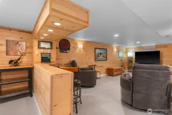 A reel den like feel with an electronic dart board. Imagine hanging out with the game on and entertaining, it's perfect for this space.