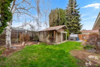 The fully fenced back yard is fully landscaped with a garden shed for all of your gardening needs