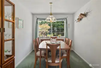 Dining room off the living room, also features large window.