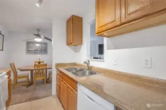 Spacious kitchen with tile flooring leading to nice sized dining room