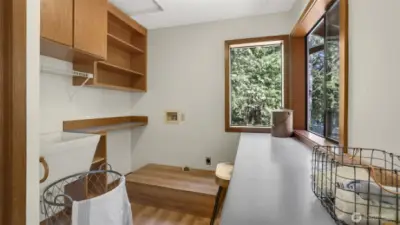 Well-organized laundry room featuring sleek wood cabinets for storage and a clean, modern look.