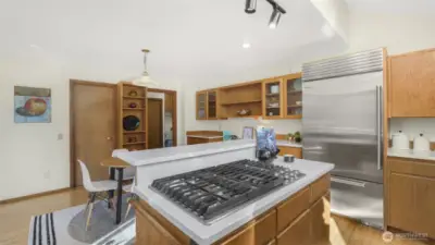 Close-up view of the stylish island stove, perfect for cooking and entertaining guests. Enjoy a Sub-Zero fridge in this high end kitchen, all appliances stay!