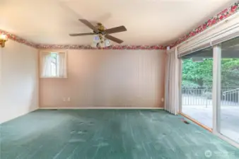 Primary bedroom with sliding doors to the covered deck and patio.