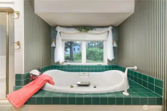 Primary jetted tub and separate walk-in shower.