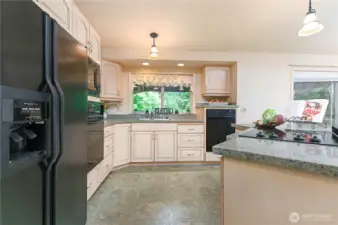 Kitchen has custom cabinets and is a great room concept.