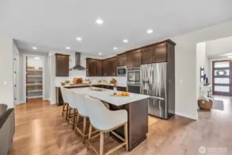 Kitchen with an eat-in island & stainless steel appliances.