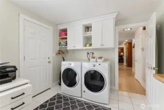 Huge mudroom / laundry room conveniently off the main floor living space with door to the backyard.