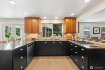 With loads of counter space, a breakfast bar/prep peninsula, Cherry upper cabinets, black lower cabinets, new appliances and gas stove top!