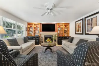 The family room fantastic installed cabinetry & shelving plus the gorgeous titled gas fireplace.