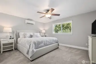 Large primary suite includes ceiling fan and split system cooling unit.  Plenty of room for a king bed and furniture pieces!