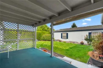 Covered Porch off Living Room with Beautifully Landscaped Backyard