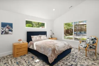 Spacious primary bedroom w/ carpet tiles