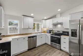 Tile counter tops, stainless steel appliances, ceiling line vaulted, an abundance of natural light.