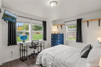 Second bedroom with vinyl plank flooring and fresh paint.
